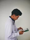 TheÃ¢â¬â¹ YoungÃ¢â¬â¹ medicalÃ¢â¬â¹ doctorÃ¢â¬â¹ standingÃ¢â¬â¹ in front of the clinicÃ¢â¬â¹ HealthcareÃ¢â¬â¹ University Hospital